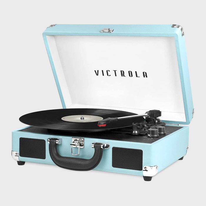 Record player spinning vinyl inside an open teal suitcase-style case with the text 