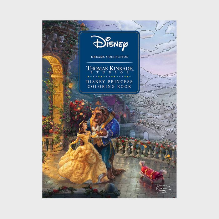 A woman and beast dance on a castle terrace surrounded by flowers, with a picturesque mountainous landscape in the background. Text: 