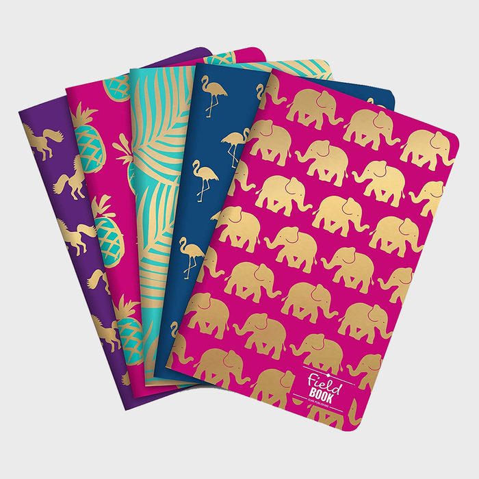 Notebooks display colorful covers with gold animal patterns, including horses, pineapples, palm leaves, flamingos, and elephants. Text: 