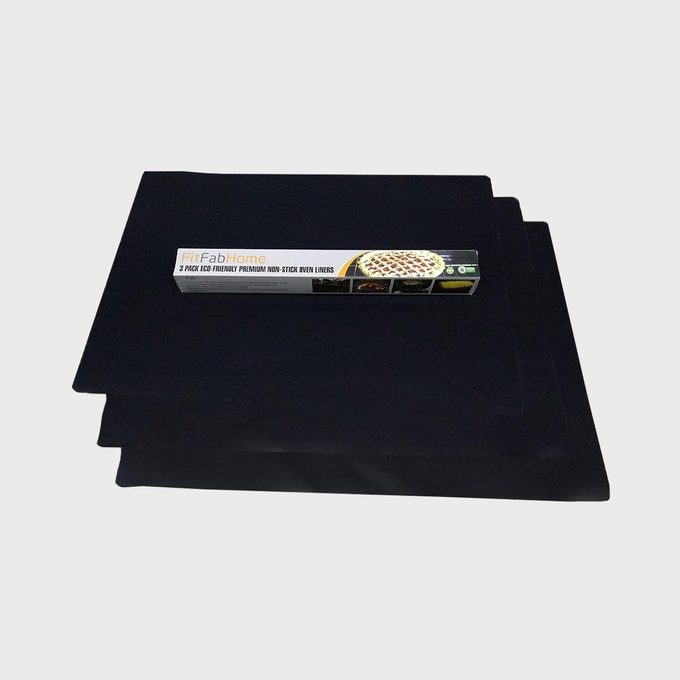 Non-stick oven liners lie flat beneath a rectangular box labeled 