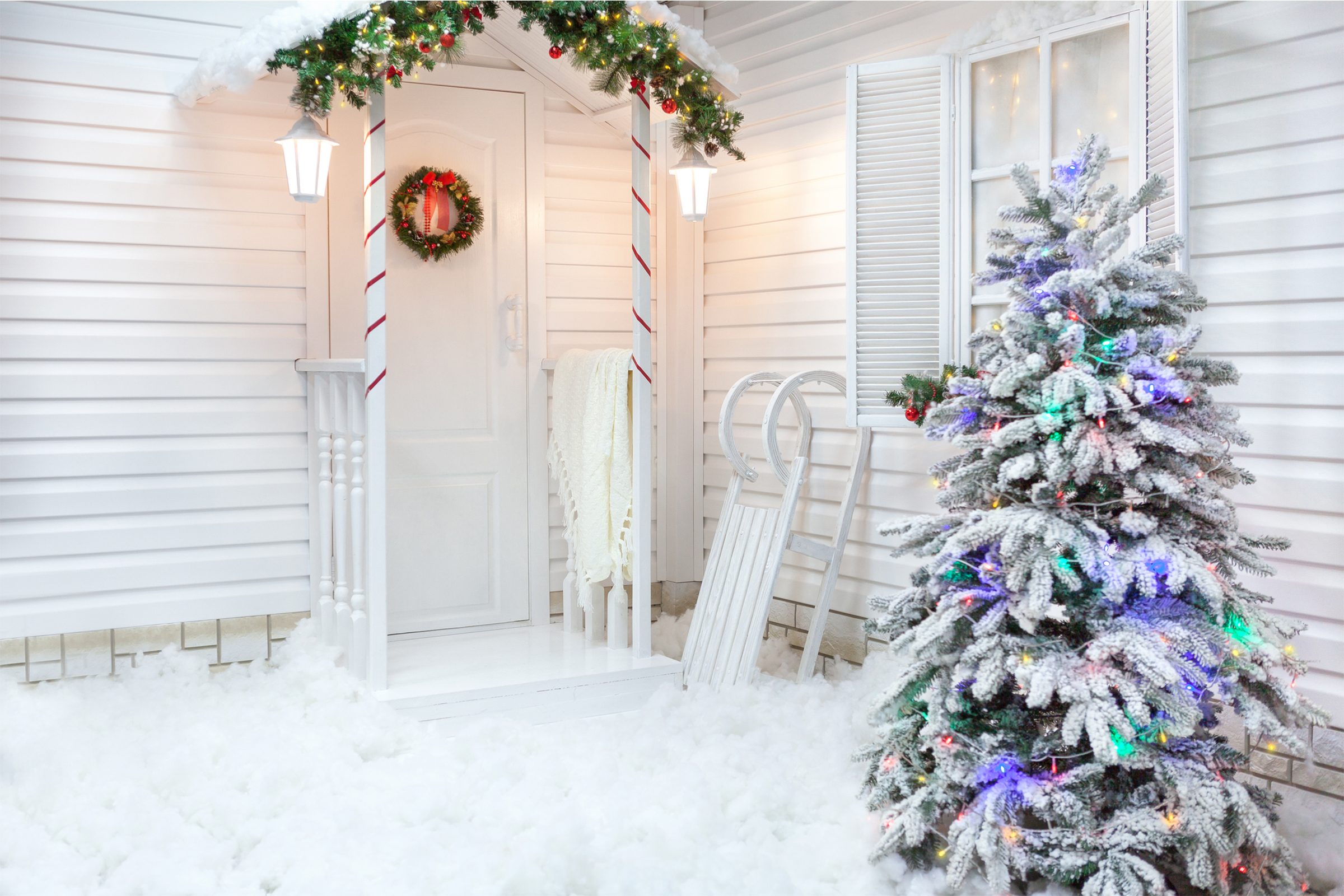 Winter exterior of a country house with Christmas decorations.