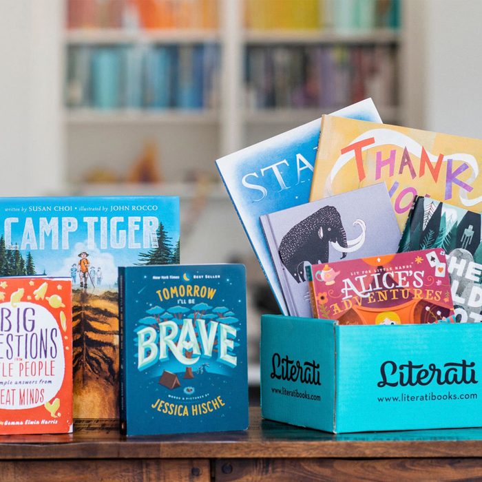 Books displayed upright, standing or in a blue 