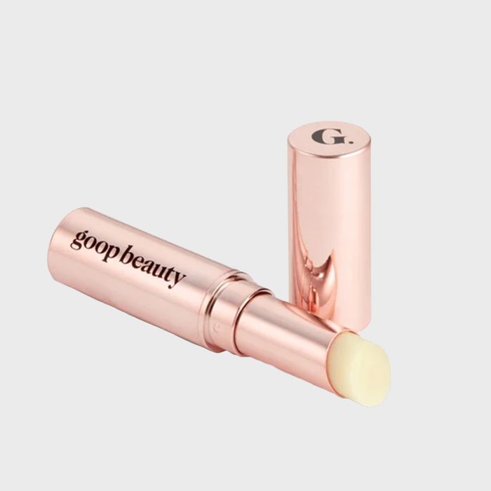Lip balm with a creamy tip lies beside a rose-gold tube. The text reads 