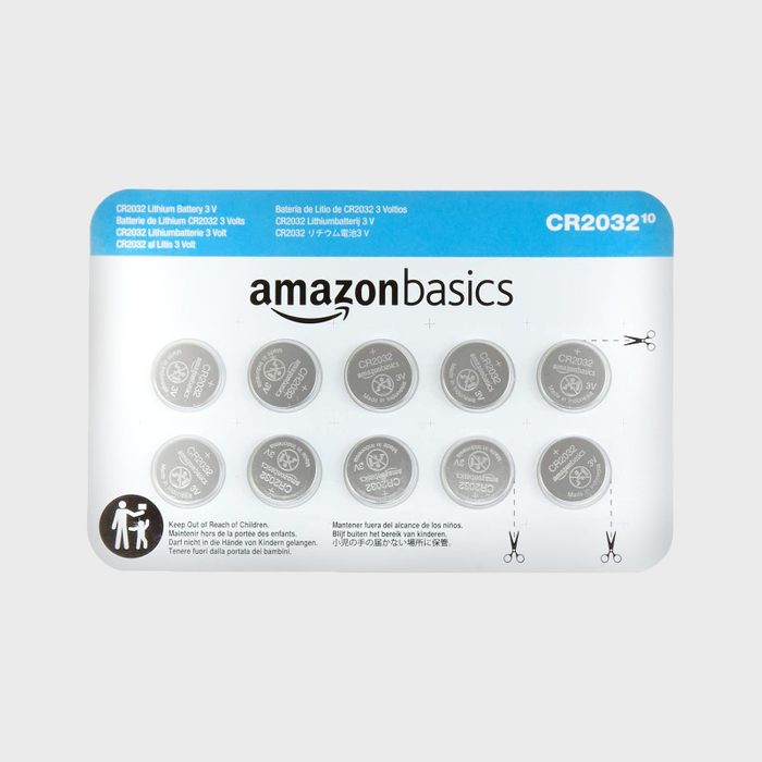 Package contains ten AmazonBasics CR2032 lithium batteries secured in a plastic casing, with safety warnings and multilingual instructions printed on the cardboard backing.