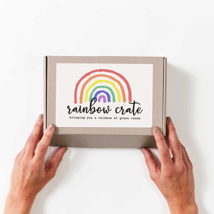 Hands holding a cardboard box labeled 
