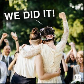 Two people embrace, celebrating with arms raised, surrounded by cheering group outdoors. Text above reads, 