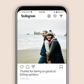 People hugging on a beach, wearing winter clothing, displayed on a phone screen. Caption reads, 