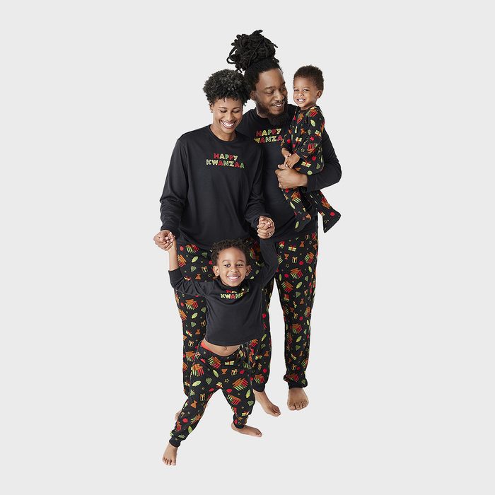 Family poses, wearing matching 