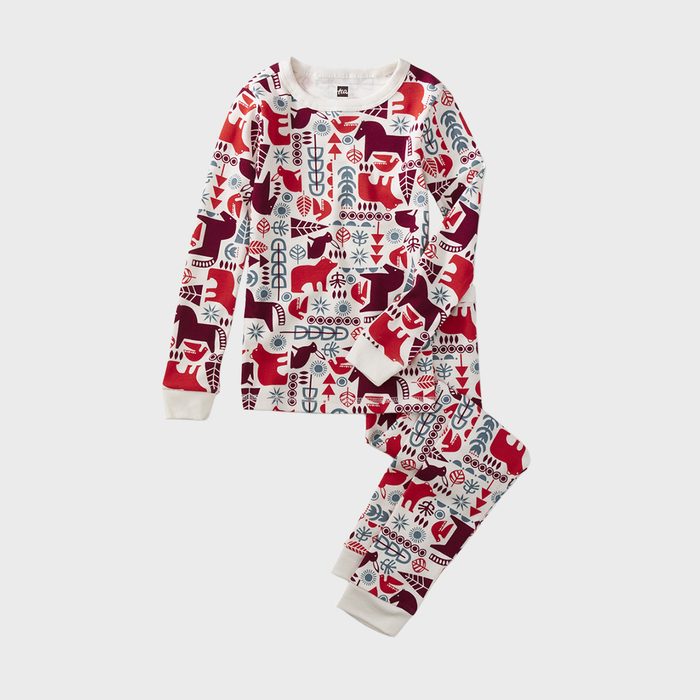 Pajamas feature colorful, abstract animal patterns; displayed on a light, plain background.