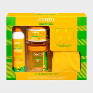 Hair products in a kit include curl activator, cream, gel, and fabric wrap, presented in a yellow and green box.