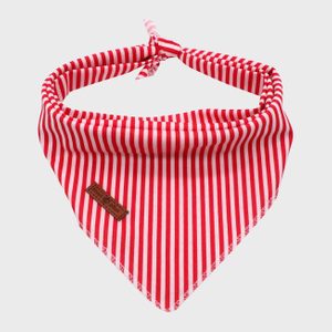 Red and white striped bandana is displayed, contrasting against a plain gray background. A leather tag is sewn near the bottom edge.