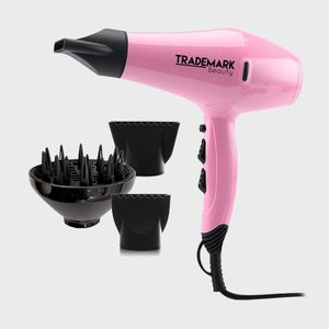 Pink hairdryer with attachments, resting against a plain background. Text reads 