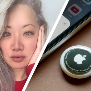 Person rests hand on face beside phone; Apple AirTag nearby on a surface.