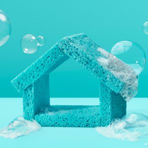Blue sponge house with soap bubbles floating, set against a teal background.
