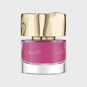 A pink nail polish bottle with a gold cap, labeled 