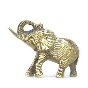 A brass elephant figurine raises its trunk, standing on a plain white background, showcasing detailed engravings and textured patterns.
