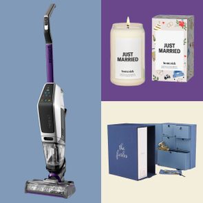 A vacuum stands upright on the left; a lit candle labeled 