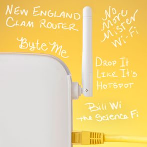Router with visible antenna and cable. Background is yellow featuring playful Wi-Fi-related text in white, such as 