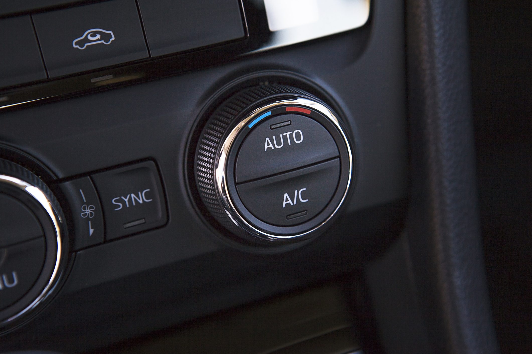 Interior of a modern automobile showing the dashboard and a/c controls