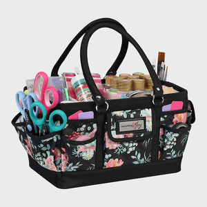 Craft supplies organize in a floral-patterned tote, featuring scissors, brushes, and various tools. The label reads 
