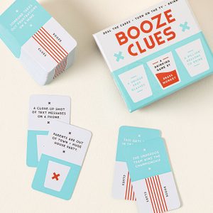 Box and cards display drinking game phrases on a light surface. Cards read: 