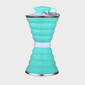 A collapsible turquoise water bottle stands upright, featuring a metal top and base, with a carabiner attached, against a plain white background.