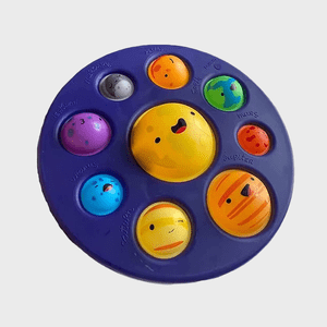 Toy solar system model features smiling planets, arranged on a dark blue round tray, labeled with names like 