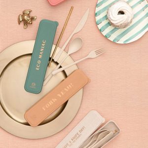 Reusable utensils rest on plates; cases labeled 