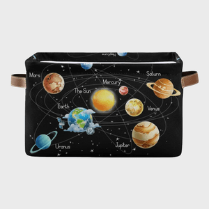 Planets orbit the sun on a fabric print with labeled orbits and stars, set on a black bag with brown handles.