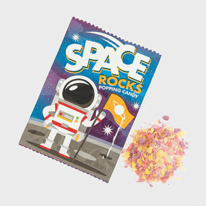 Candy packet displays astronaut holding flag; colorful candy pieces scattered beside. Text reads: 