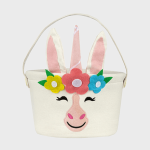 A fabric basket features a unicorn face with felt flowers and ears, against a plain background.