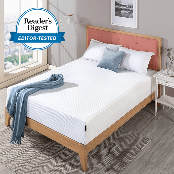Bed with white sheets and pillows sits in a cozy bedroom with a rug and window view. Text: 