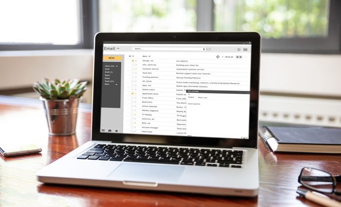 Emails list on a laptop screen, office workspace