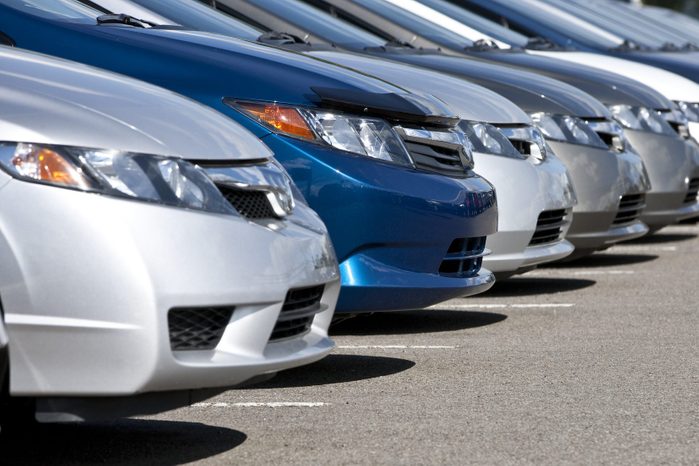 Line of compact cars at a dealership.