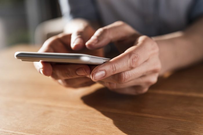 Woman's hands text messaging, close-up