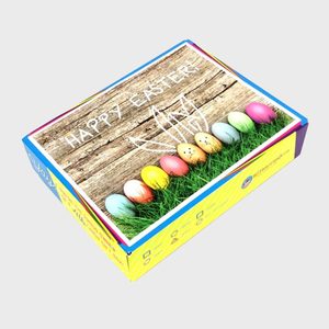 Box top shows colorful Easter eggs on grass; text reads 
