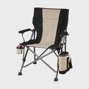 Folding camping chair holds a drink in an attached cup holder, with a small cooler hanging from its side, isolated on a gray background.