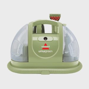 A compact carpet cleaner sits with its hose coiled, displaying its brand and name, Bissell Little Green, on a simple background.