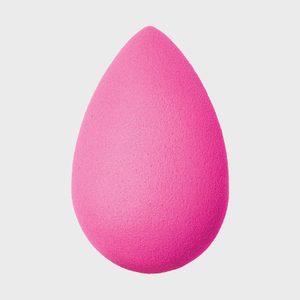 Pink sponge appears still against a plain white background.
