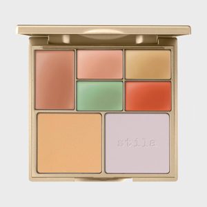 Makeup palette displays variously colored creams. Set in a gold case. The text 