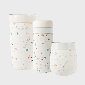 Three white, terrazzo-patterned drinkware items in varying sizes standing together against a plain backdrop, featuring the text 