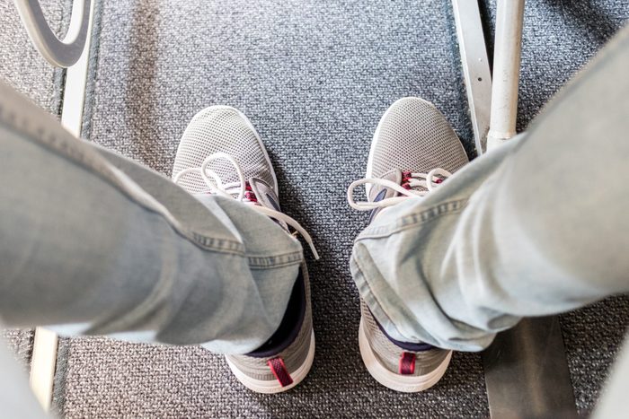 Male Passenger With Lack Of Leg Space On Long Commercial Airplane Flight