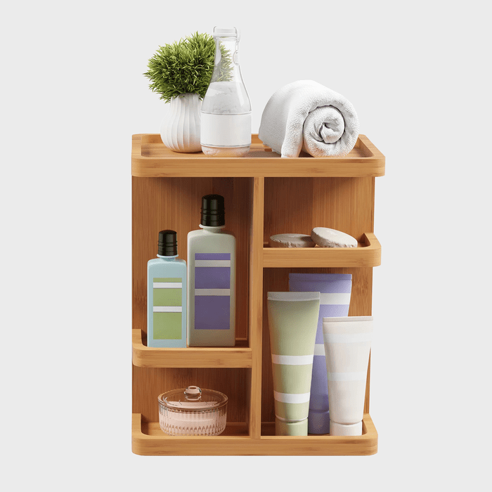 Wooden shelf holding toiletries, rolled towel, plant, and bottles; neatly arranged, creating an organized bathroom setting.