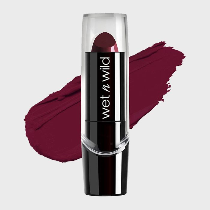 Lipstick stands upright, showcasing deep plum color, labeled 