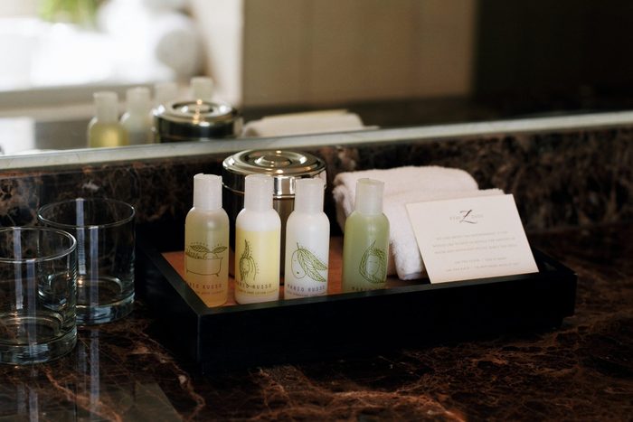 hotel shampoo and condtioner bottles on a tray in the bathroom