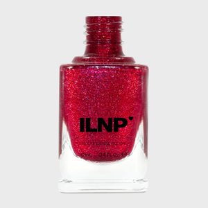 A bottle holds shimmering red nail polish, open, with 