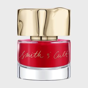 Red nail polish bottle with gold cap, displaying 