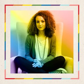 A person sits cross-legged on a chair, surrounded by a colorful gradient background, appearing to be in a calm and relaxed environment.