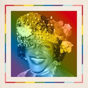 Smiling person wears a floral headpiece, set against a vibrant rainbow background with a colorful border.