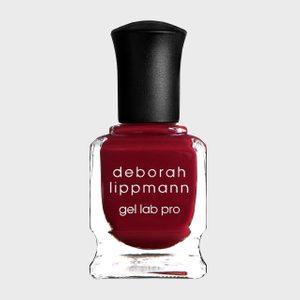 Nail polish bottle contains deep red color; labeled 